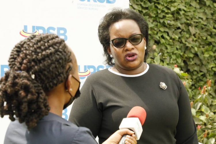 Ms Mercy Kainobwisho in black talks to journalists during the conference 