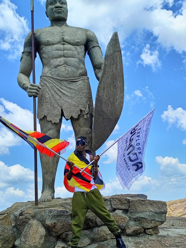 Legendary musician Dr. Jose Chameleon poses with Uganda and Explore Uganda flag